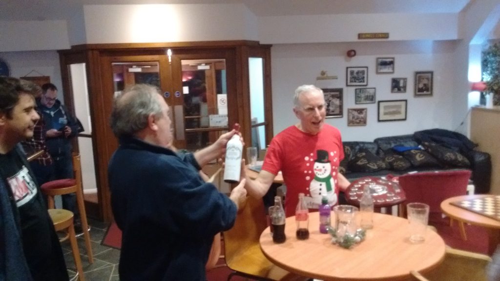 Ken receives the coveted wooden spoon (and a bottle of wine)